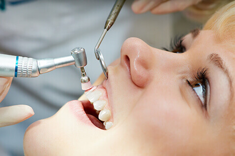 Woman having teeth cleaned