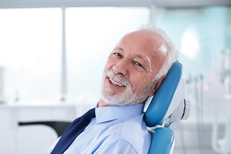 Smiling man in dentist's chair